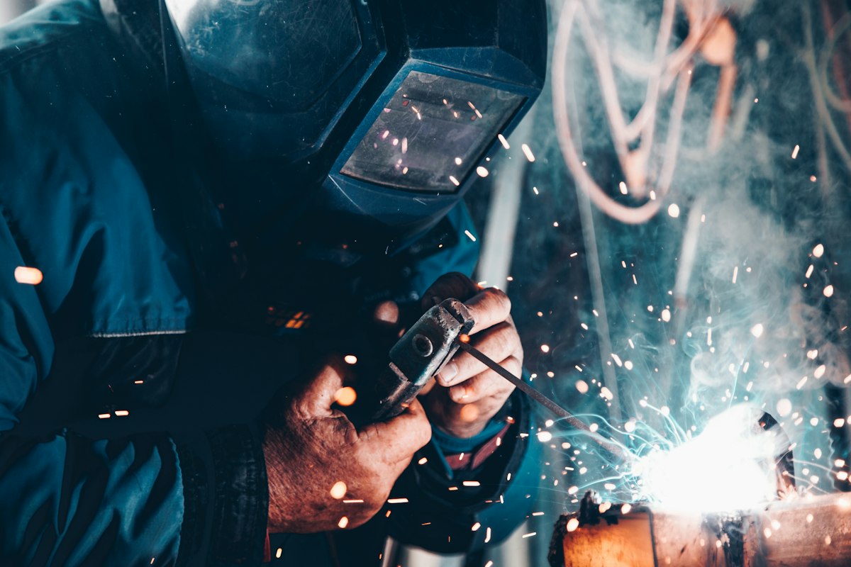 Welder working with sparks in a workshop